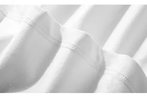 Close-up of white oversized t-shirt showing fine stitching and twill fabric texture