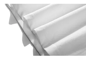 Close-up of white knitted cotton fabric texture with fine jacquard pattern and soft folds