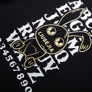 Oversized black T-shirt featuring golden rabbit graphic and bold white typography design