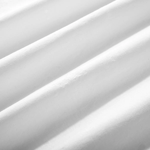 Macro texture of soft white jacquard fabric with diagonal drape and fine woven details