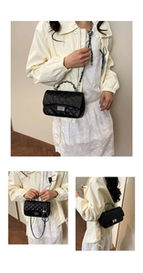 Detailed view of black quilted leather shoulder bag with silver chain strap and twist lock