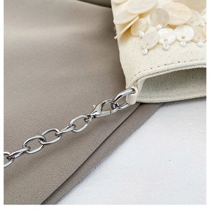 Detail of silver chain strap with lobster clasp on handmade sequin shoulder bag
