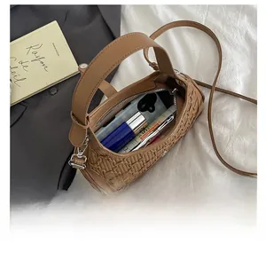Top-down view of woven crossbody bag interior showing spacious storage for makeup and phone