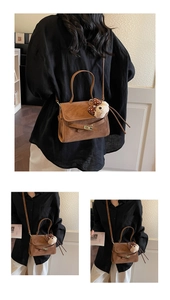 Detail of a brown matte shoulder bag with a decorative strap and cute plush bear charm