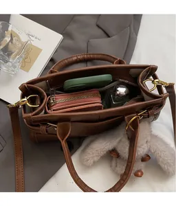 Macro shot of spacious brown PU leather bag interior with neat organizer compartments