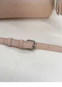 Detail of adjustable pale pink leather strap with silver buckle for crossbody bag