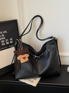 Retro black faux leather tote bag with long straps and brown plush bear charm