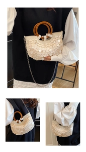 Detail of white sequined crescent bag featuring wooden ring handles and chain strap