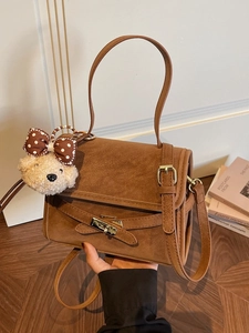 Vintage brown suede shoulder bag with gold twist lock and cute bear charm pendant