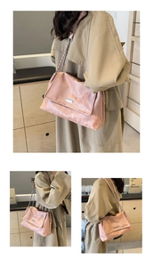 Pink oily leather tote bag with metal chain strap worn on a beige trench coat