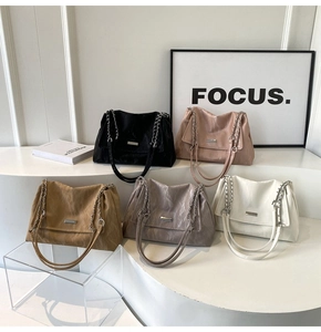 Detailed view of fashionable chain tote bags in black, pink, brown, taupe and white colors