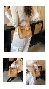 Detail of woven bucket bag featuring a cross-braid texture and cute plush bear charm