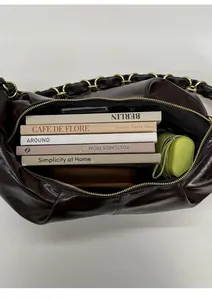 Interior detail of large capacity brown leather dumpling bag showing ample storage space