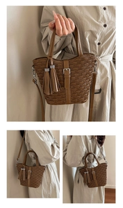 Detail of pleated texture on brown bucket bag with leather tassel and rhinestone trim
