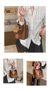 Detailed weave pattern on brown bucket bag with gold buckle and plush bear charm
