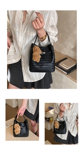 Detail of black woven leather bucket bag featuring a cute brown plush bear charm