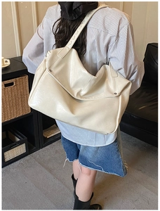 Detailed back view of a large cream white faux leather hobo shoulder bag for daily commute