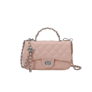 Pale pink quilted chain crossbody bag with silver twist lock on white background