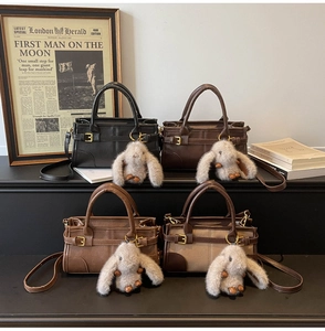 Detailed view of vintage-style handbags in four colors with cute bunny charms