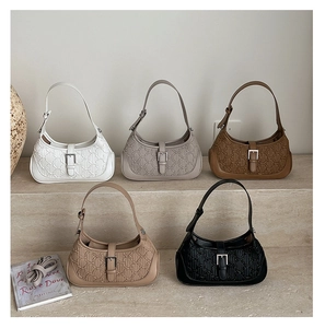Detail showing five colors of embossed half-moon bags with stylish buckle and textures
