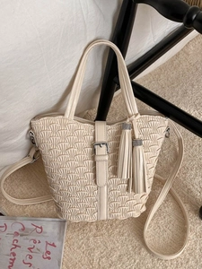 Chic beige pleated bucket bag with leather buckle, tassel charm and round top handle