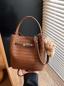 Brown woven bucket bag with metal twist lock and cute plush puppy charm for women