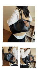 Detail of black pleated tote bag in premium PU leather with cute brown bear charm
