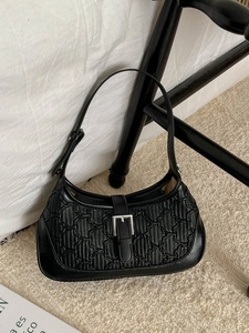 Minimalist black crescent shoulder bag with embossed texture and silver buckle detail