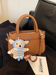 Brown leather crossbody handbag with textured lychee grain and cute sheep pendant