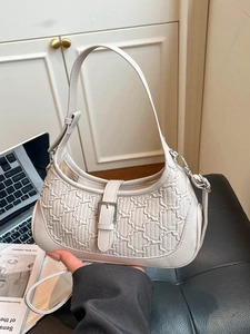 Minimalist beige half-moon hobo bag with embossed texture and adjustable handle