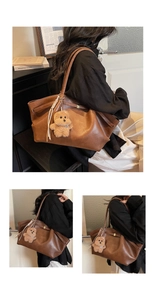 Detail of dark brown leather tote bag with a cute plush bear charm and white woven lanyard