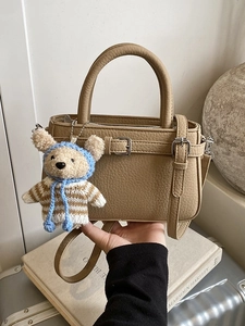 Khaki pebbled leather handbag with double handles and a cute teddy bear charm