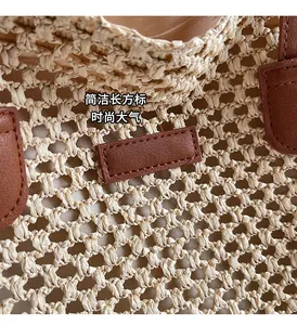 Close-up of beige woven straw tote bag with brown leather tag and detailed knit texture