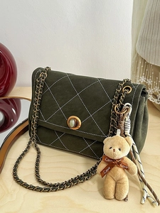 Quilted olive green crossbody bag with gold chain strap and plush bear keychain decoration