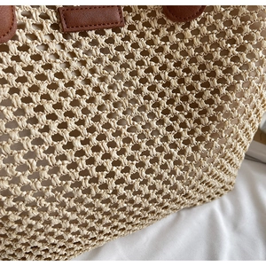 Close-up of hollow straw weave pattern with brown leather trim and soft cotton lining