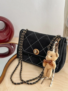 Quilted black chain crossbody bag with white diamond pattern and cute bear charm