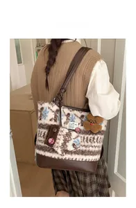 Detailed back view of a large wool tote bag with blue snowflake patterns and bear charm