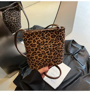 Détail du sac seau à imprimé léopard avec texture en daim et fine bandoulière marron