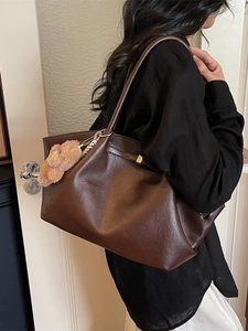 Vintage brown leather tote bag with large capacity and cute plush bear charm for daily commute
