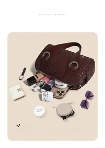 Deep burgundy woven pillow bag interior showing high capacity for iPad and daily essentials