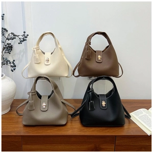 Close-up of four lychee texture leather handbags with golden twist lock in various colors