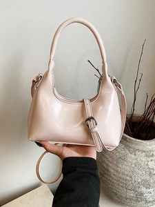 Light pink patent leather crescent hobo bag with adjustable strap and glossy finish