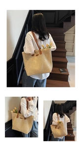 Detail of woven straw tote bag featuring diamond pattern, leather straps and tulip decor