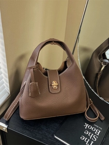 Vintage brown pebbled leather handbag with contrast stitching and gold twist lock