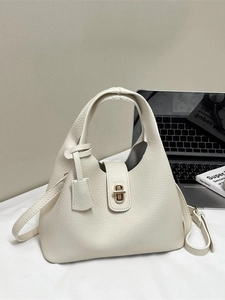 Chic white lychee leather handbag with gold twist lock and adjustable crossbody strap