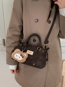 Dark brown vintage Boston bag with plush charm, top handles and adjustable shoulder strap