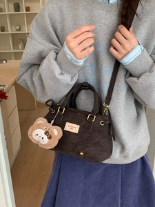 Deep brown retro faux suede shoulder bag with plush bear charm and sturdy top handles