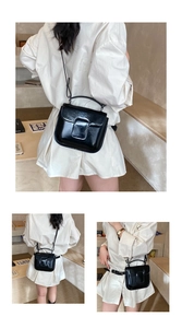 Detail of black glossy leather square crossbody bag with elegant top handle and strap