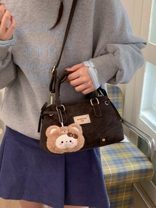 Brown suede underarm shoulder bag with adjustable strap and cute teddy bear pendant