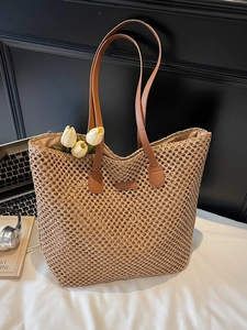Beige hollow straw tote bag with brown leather straps and interior lining for women